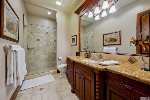 bathroom featuring toilet, a shower with door, vanity, and a notable chandelier