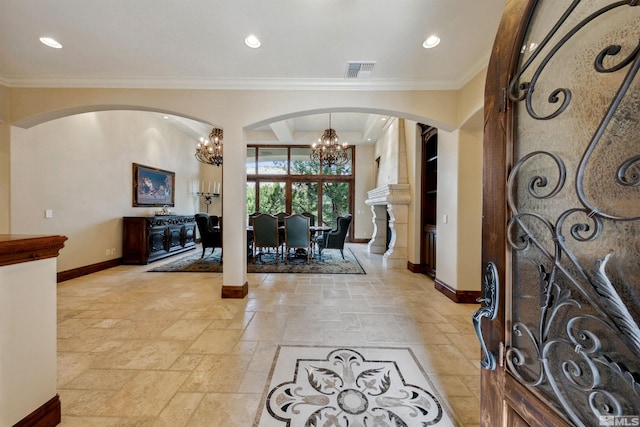 foyer with a notable chandelier and ornamental molding