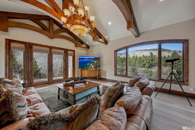 living room with french doors, a notable chandelier, and a healthy amount of sunlight