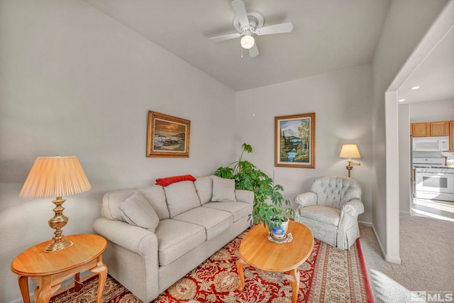 carpeted living room with ceiling fan