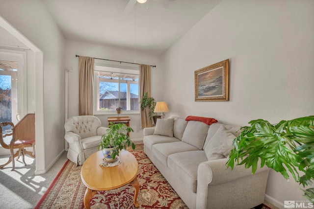 living room featuring light carpet and ceiling fan