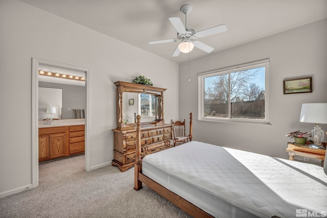 bedroom with sink, ensuite bath, light carpet, and ceiling fan