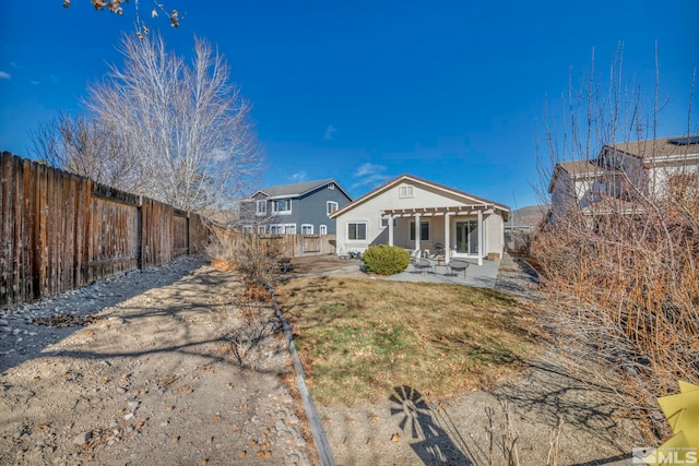 rear view of house with a patio and a pergola