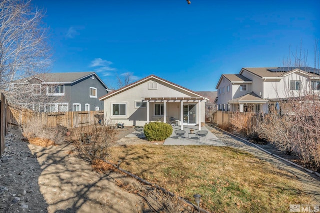 rear view of property with a pergola and a patio