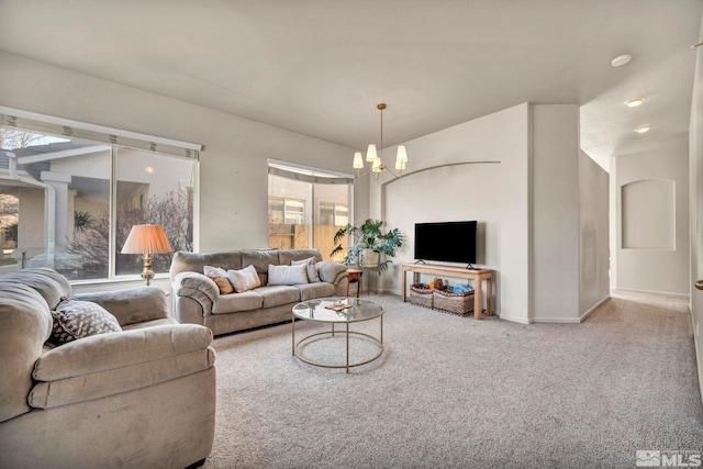 living room with an inviting chandelier and carpet floors