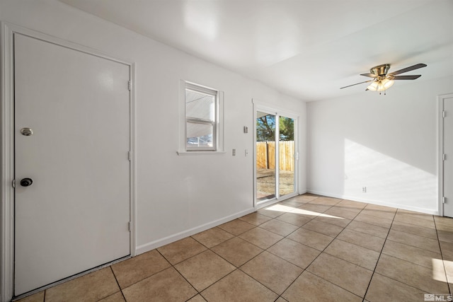 spare room with ceiling fan and light tile patterned floors