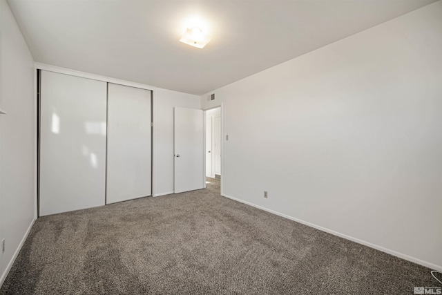 unfurnished bedroom featuring a closet and carpet