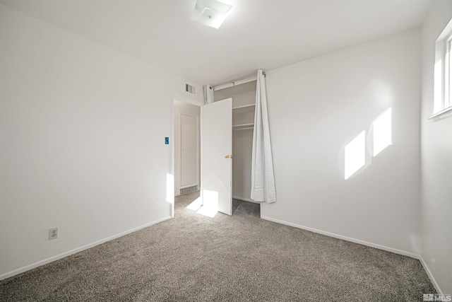 unfurnished bedroom with a closet and carpet