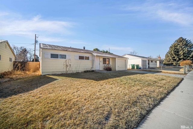 ranch-style home with a front yard and a garage