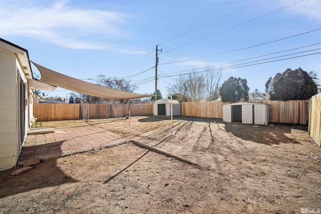 view of yard with a patio area and a storage unit