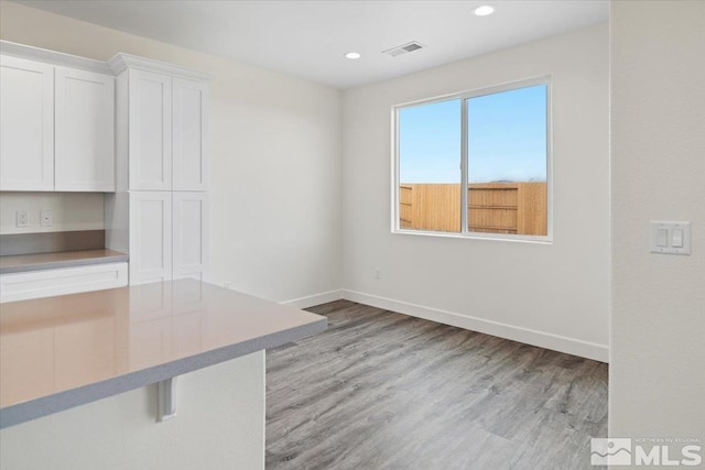 unfurnished dining area with light hardwood / wood-style flooring