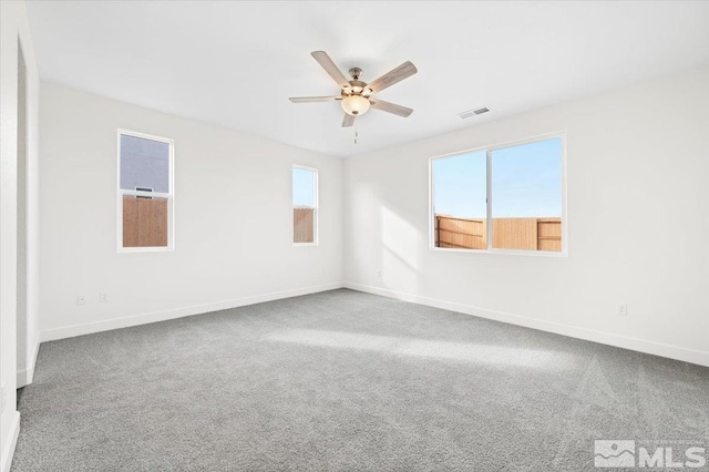 carpeted spare room with ceiling fan