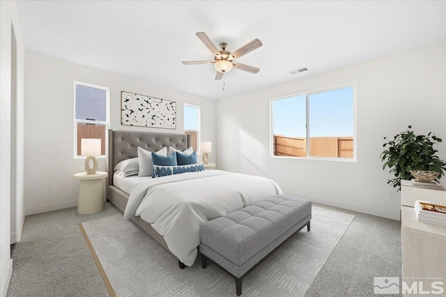 bedroom with light carpet and ceiling fan