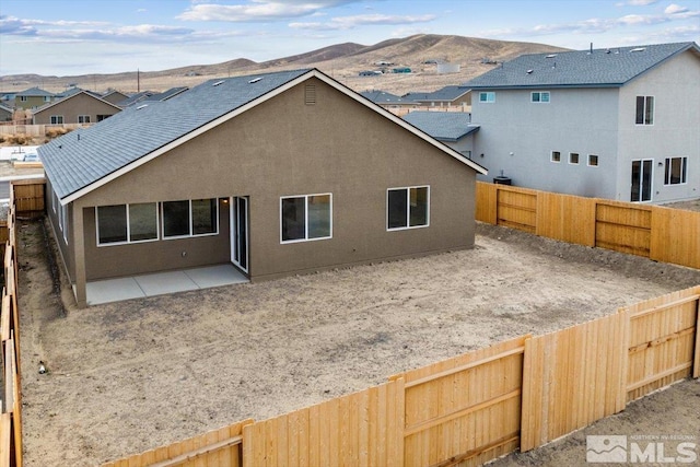 rear view of property featuring a patio and a mountain view