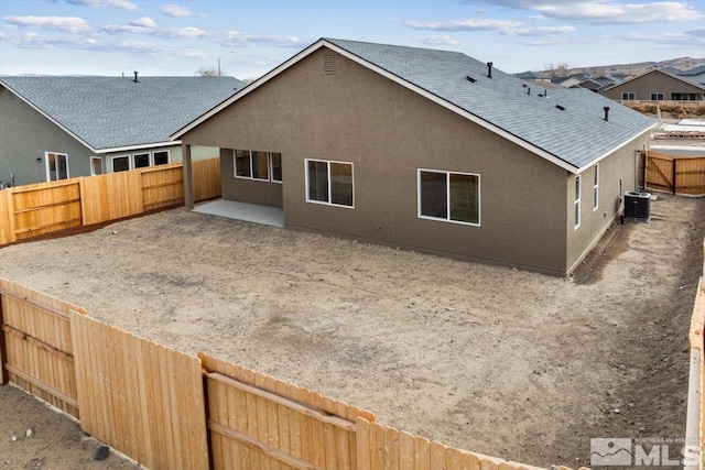 rear view of house featuring a patio area and central AC unit