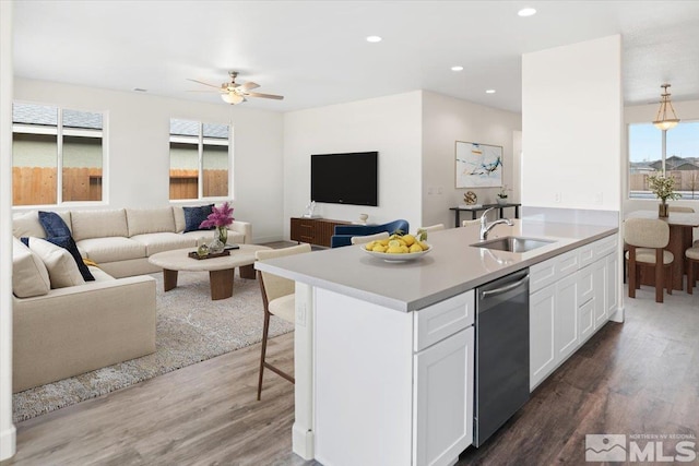 kitchen with sink, white cabinetry, dishwasher, and plenty of natural light