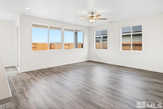 empty room featuring ceiling fan and dark hardwood / wood-style floors