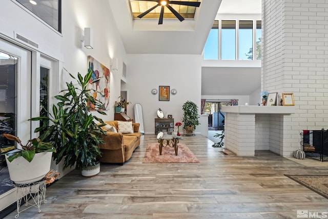 interior space featuring a towering ceiling and light hardwood / wood-style flooring