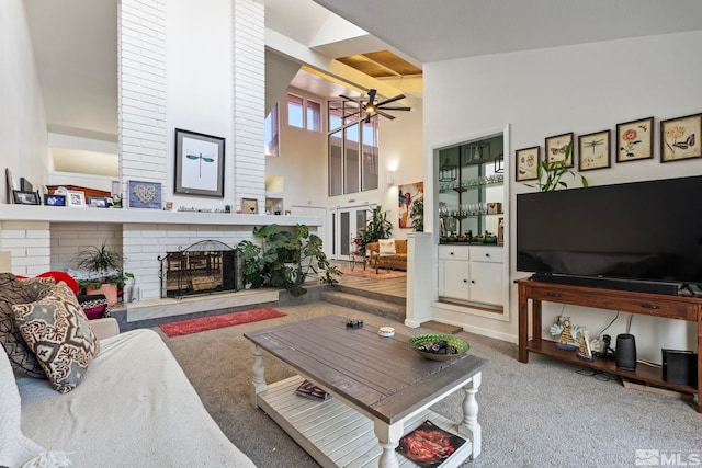 carpeted living room featuring high vaulted ceiling, a fireplace, and ceiling fan