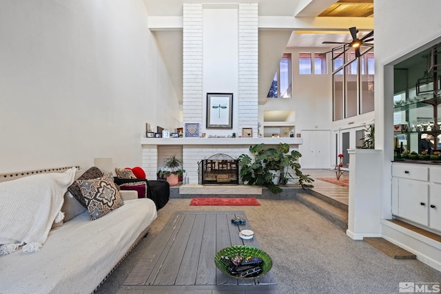 living room with ceiling fan and a brick fireplace