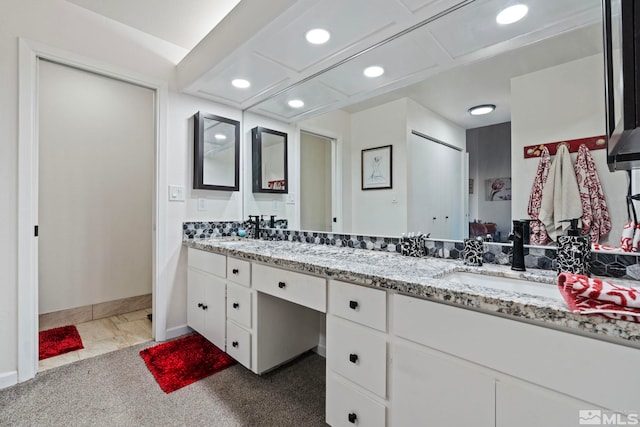 bathroom featuring coffered ceiling and vanity