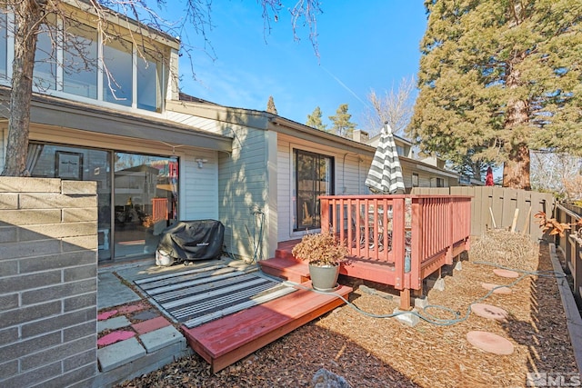 wooden terrace featuring a grill