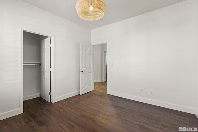 unfurnished bedroom featuring dark hardwood / wood-style flooring