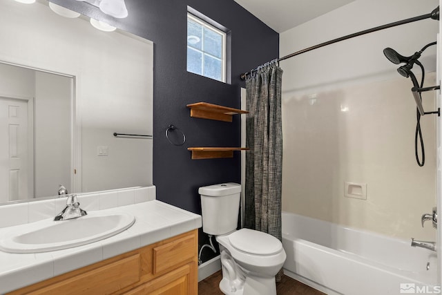 full bathroom with vanity, shower / bath combo with shower curtain, and toilet