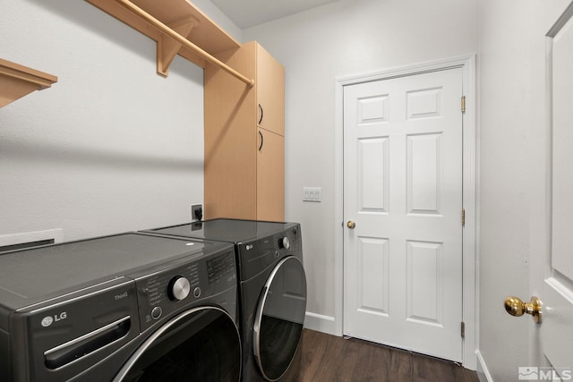 clothes washing area featuring washer and clothes dryer and dark wood-type flooring