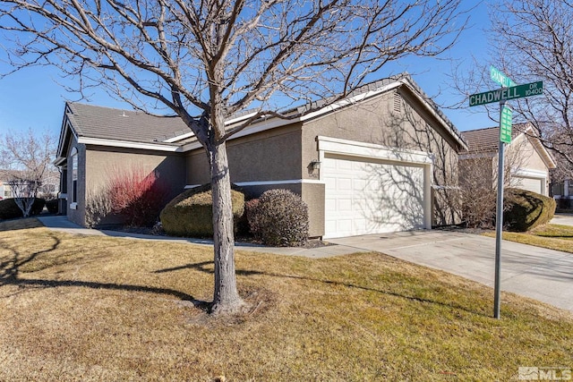 view of side of property featuring a yard and a garage