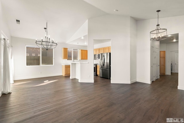 unfurnished dining area with lofted ceiling, a notable chandelier, and dark hardwood / wood-style floors