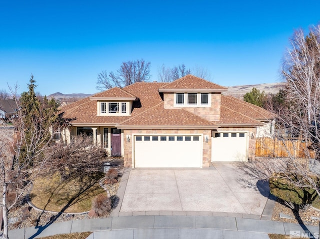 front of property with a mountain view and a garage