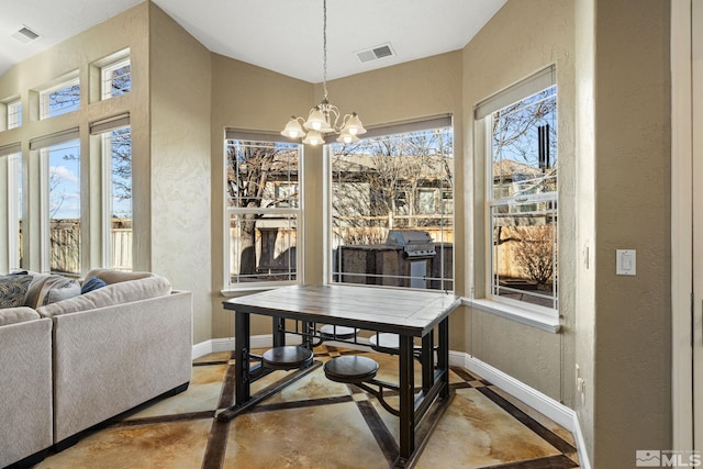 dining space with a wealth of natural light and a chandelier