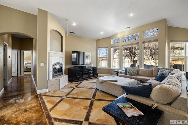 living room featuring a tiled fireplace