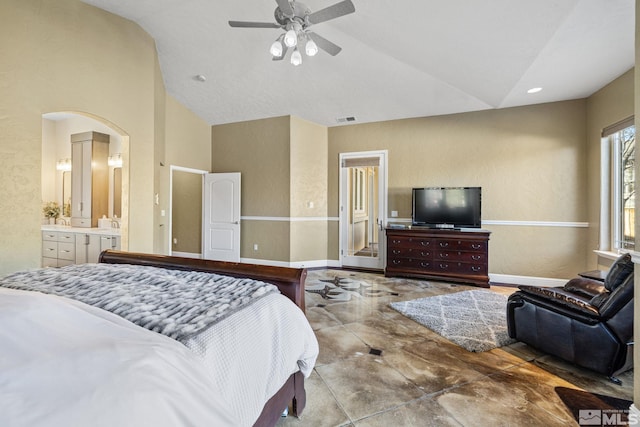 bedroom with ensuite bath, ceiling fan, and vaulted ceiling