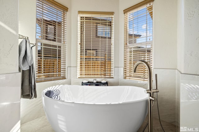 bathroom with a healthy amount of sunlight and a bathtub