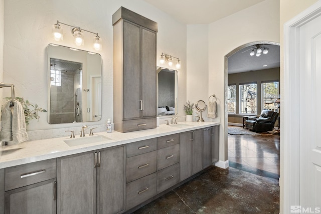 bathroom featuring walk in shower and vanity