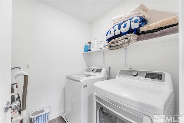 laundry room featuring washer and dryer and hardwood / wood-style floors