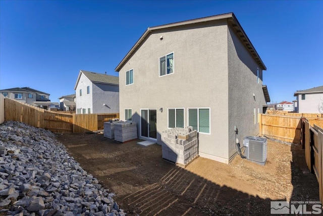 rear view of house featuring central air condition unit