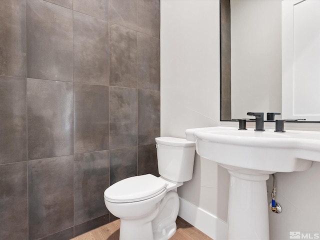 bathroom with toilet and wood-type flooring