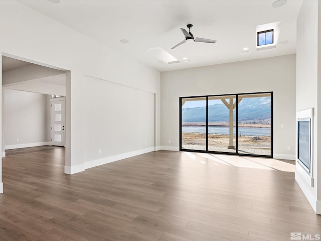 spare room with ceiling fan and wood-type flooring