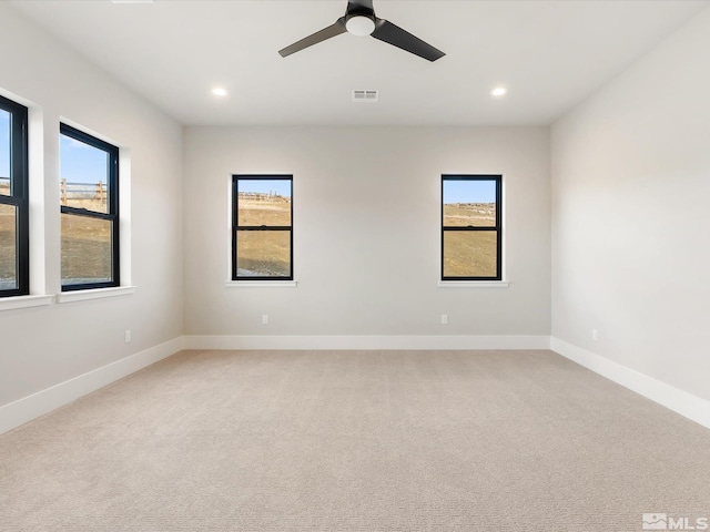 spare room featuring carpet floors and ceiling fan