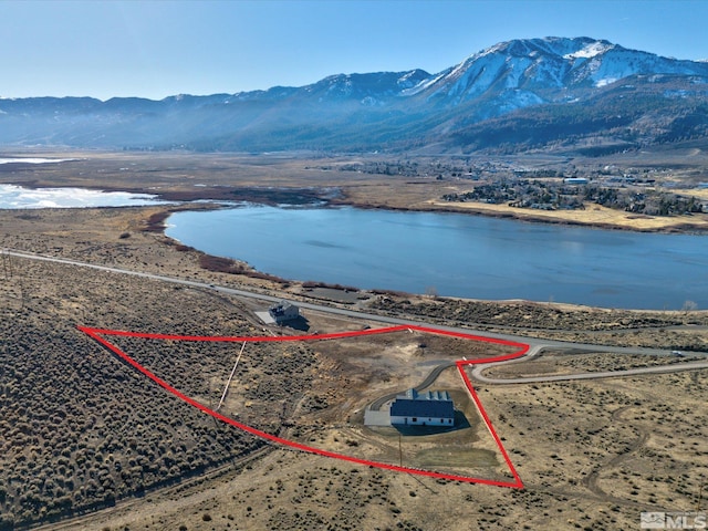 birds eye view of property featuring a water and mountain view