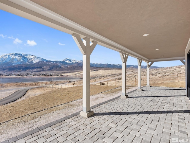 view of patio with a rural view and a mountain view