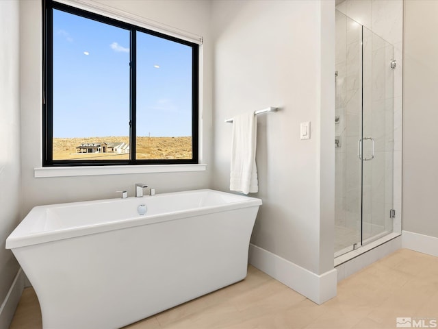 bathroom featuring shower with separate bathtub