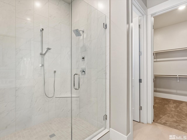 bathroom featuring walk in shower and tile patterned flooring