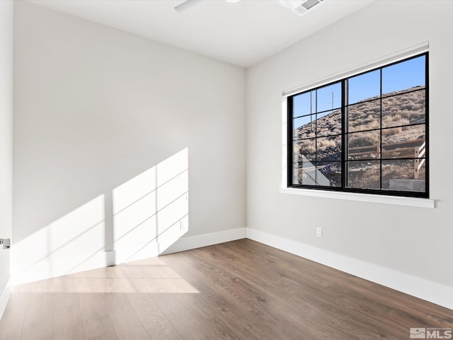 spare room with hardwood / wood-style floors