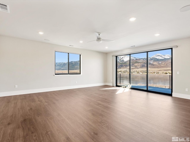 spare room featuring ceiling fan and hardwood / wood-style flooring