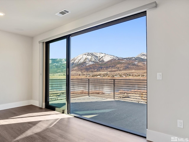 entryway with hardwood / wood-style floors and a mountain view