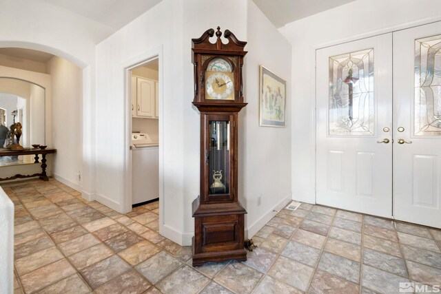 foyer entrance with washer / dryer